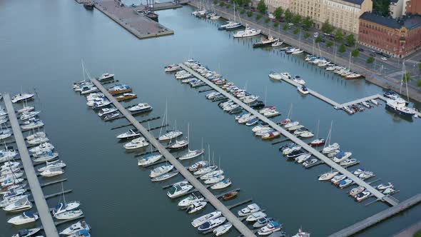 Slow aerial pan up of dock in port city of Helsinki, Finland at dusk.