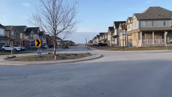 Going through a roundabout in a suburb community neighborhood of homes