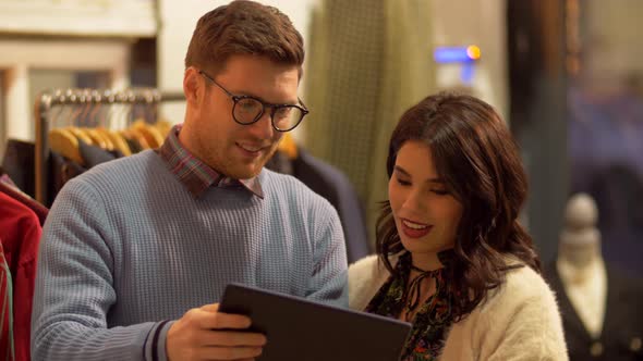 Couple with Tablet Pc at Vintage Clothing Store 49