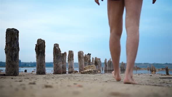 Man Walking On Abandoned Beach