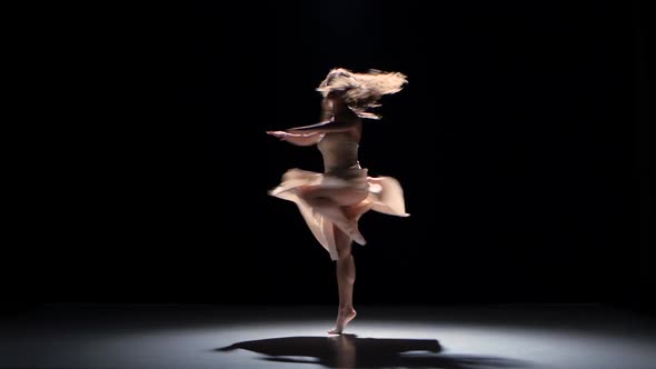 Young Woman Dancer Dancing Contemporary Dance and Doing a Split, on Black, Shadow