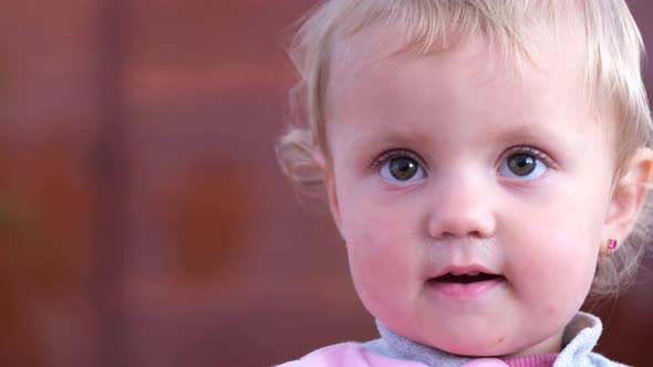 Happy and Smiling Little Girl She Looks at the Camera and Rejoices