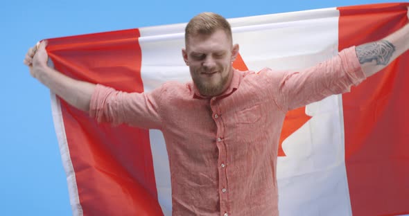 Young Man Dancing and Holding Canadian Flag