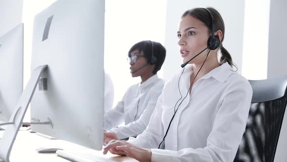Call Center Agents Consulting Clients On Hotline At Office