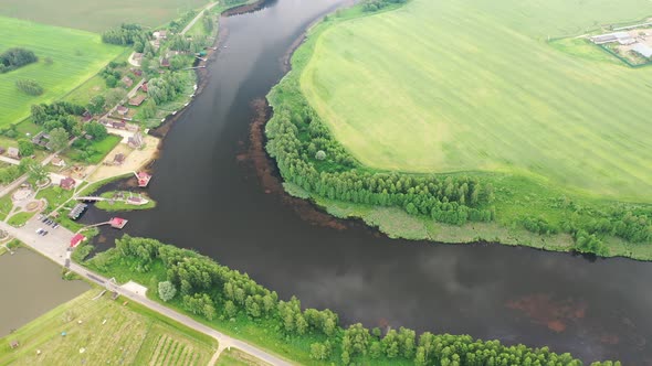 View From the Height of the Lake in a Green Field in the Form of a Horseshoe and a Village in the