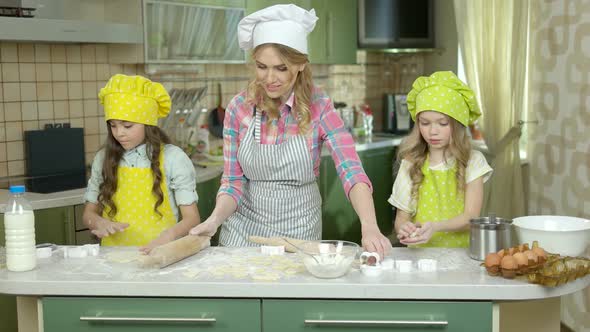 Mother and Children Making Pastry.