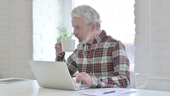 Hardworking Casual Old Man Drinking Coffee and Working