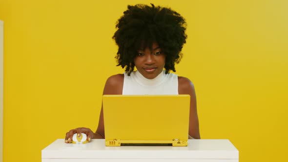 Stylish Black Woman Uses Yellow Laptop