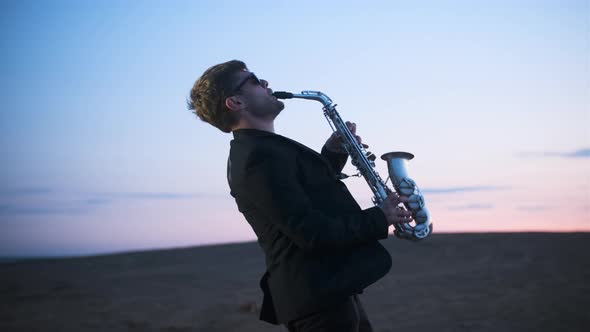 Bearded Musician in Sunglasses and Black Jacket Performs His Part on Beautiful Shiny Saxophone at
