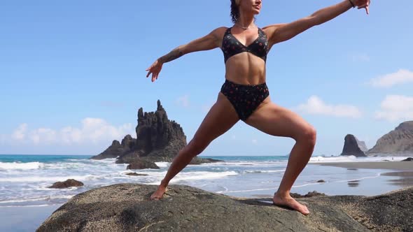 Girl Doing Yoga Balancing on One Leg Standing on a Stone. Peace of Mind. Healthy Lifestyle