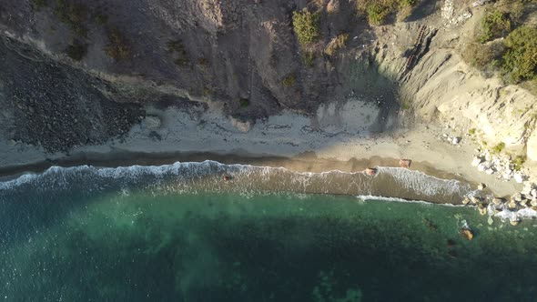 Aerial View From Above on Calm Azure Sea and Volcanic Rocky Shores