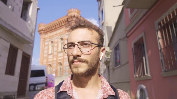 Handsome young man walking on the street.