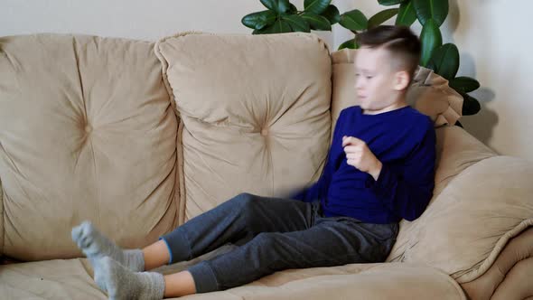 Cute kid playing games on smartphone. Little boy playing tablet game. Peaceful pastime.