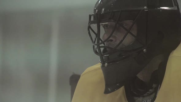 An ice hockey goalie protects his goal.