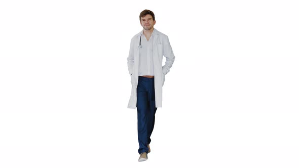 Male Doctor in White Coat Walking with Hands in Pockets Looking Straight Ahead on White Background.