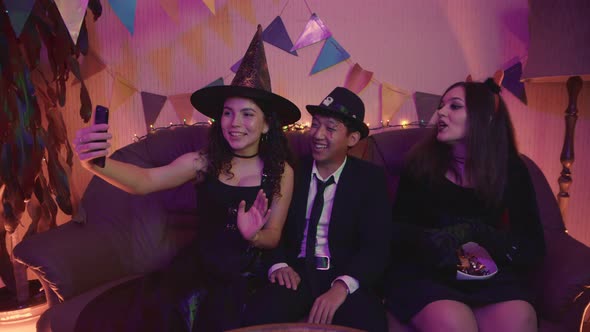 A Group of Friends in Creepy Costumes Communicate Via Video Link Via Phone and Laugh on Halloween