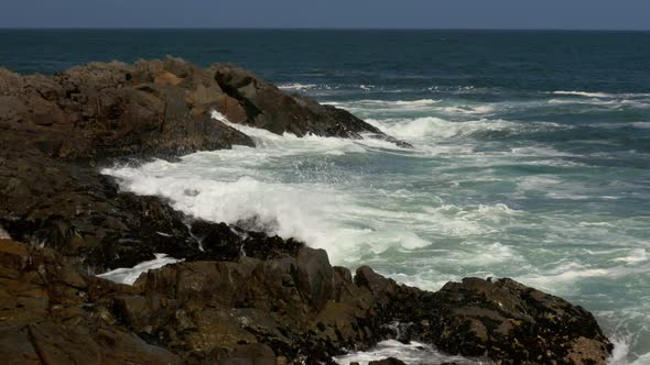 Waves break over the rocky shoreline on the Atlantic coast