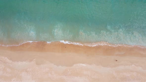 Sea wave on Beach sand in sunset. Aerial view shot on drone camera hight quality Nature and travel c