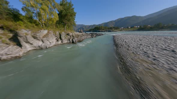 FPV Sports Drone Shot Active Travel Woman Walking Sharp Cliff Stone Structure Near River Water Flow