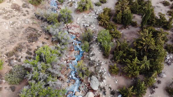 Aerial drone shot following river from above at low altitude