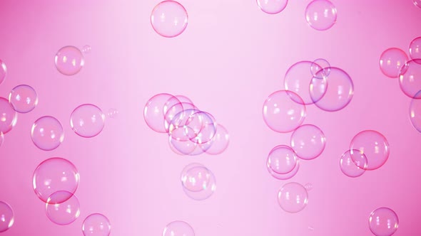 Super Slow Motion Shot of Flying Colorful Soap Bubbles on Pink Background at 1000 Fps