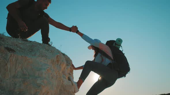 Climber Helping Teammate Climb, the Man with the Backpack Reached Out a Helping Hand To His Friend