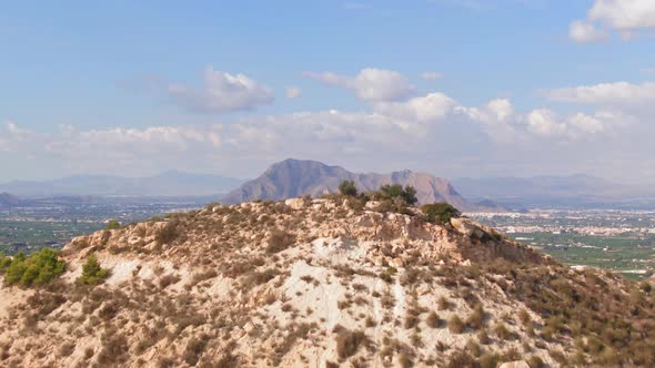 Drone Flying Over Mediterranean Hill To Reveal Spanish Mountain Sierra De Callosa De Segura.