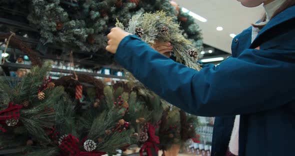 Portrait of Young Woman Shopping in Supermarket Christmas Wreath