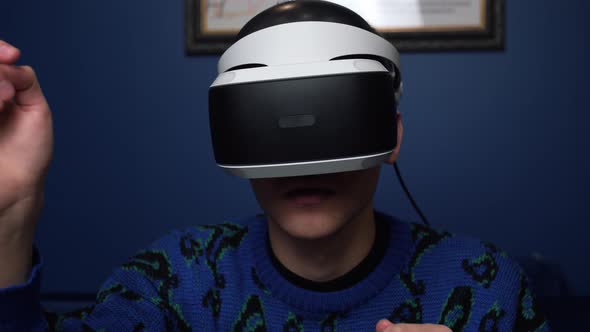 Close Up Slow Motion Scene Video of a Caucasian Man Using a VR Headset Helmet Device To Play Video