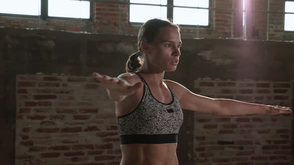 Exercise. Fit woman warming up before fitness workout at gym