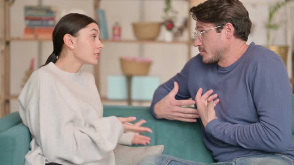 Couple Having Argument While Sitting on Sofa