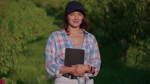 Outdoor Portrait of a Modern Woman Farmer with Touch Pad