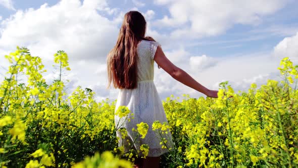 Romantic couple holding hands while walking in field