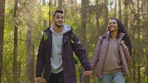 Couple in Love Enjoying Walk in Autumn Forest Holding Hands Talking Young Adventurous Hikers Walks