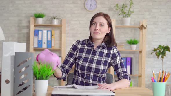 Young Disappointed Woman Shakes a Moneybox Slow Mo