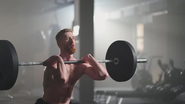 Slow Motion Male Powerlifter Preparing for Training in Gym