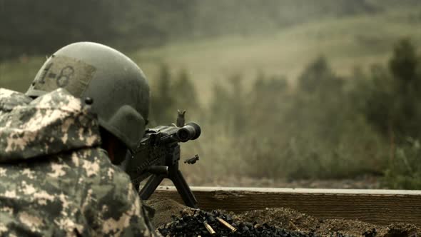 Normal speed to super slow motion shot of soldier shooting chain gun.