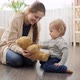 Mother playing with her baby son with teddy bear - VideoHive Item for Sale