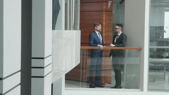 Business Men in Suits Talking in Office