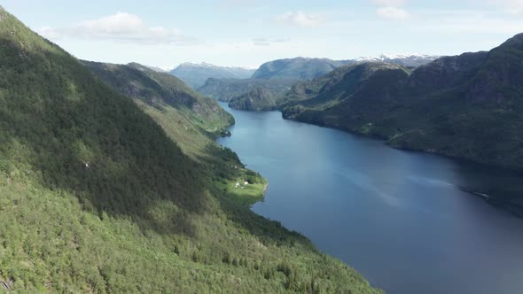 Aerial descending along evergreen Mountainside over Scenery fjord Veafjorden - Norway