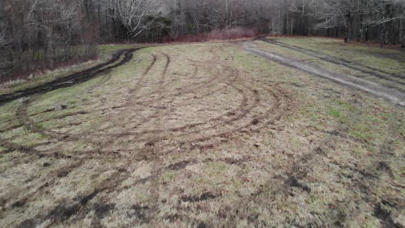 tire tracks in grass field destroyed aerial drone tracking