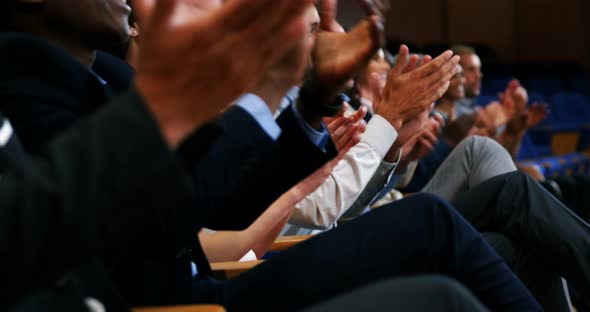 Business executives applauding in a business meeting