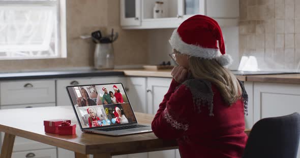 Caucasian woman spending time at home wearing santa hat