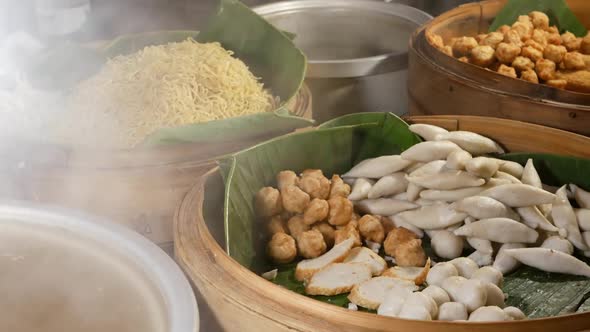 Bowls with Various Asian Dishes in Diner. Wooden Bowls with Assorted Traditional Thai Dishes for