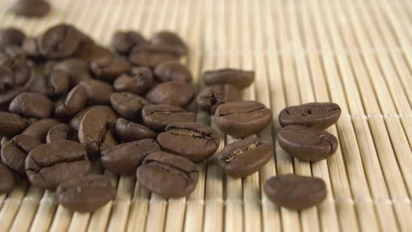 Roasted arabica coffee beans on a bamboo mat