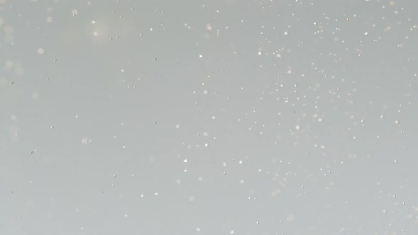 Slow Motion Macro Shot of a Lemon Slice in Water Bubbles Drinking Cold Lemonade