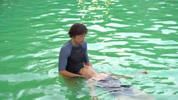 A Master of Watsu Massage Conducts a Massage in the Pool