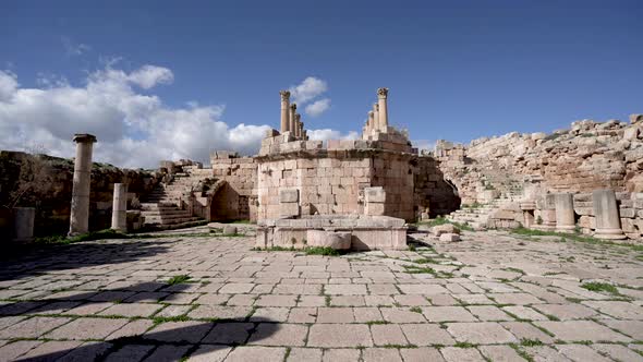 Ruins of Ancient Stone Church with Well and Curved Stairs in Roman Ruins in Jerash