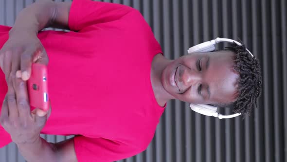 Vertical View of Young African American Man Using Mobile Phone