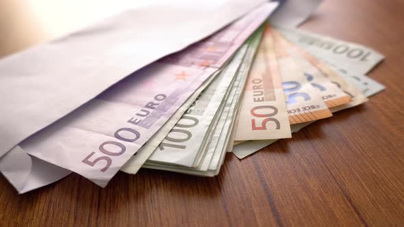 Euro Money Banknotes. Hands counting Euros bills as part of the united country's payment system.